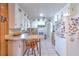 Functional kitchen with tiled floor, white appliances, and casual bar seating for easy meals and conversation at 10119 Cliff Cir, Tampa, FL 33612