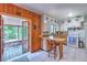 Quaint kitchen with white cabinets, breakfast bar, with an adjacent screened-in porch providing ample light at 10119 Cliff Cir, Tampa, FL 33612