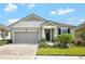 Charming single Gathering home featuring manicured landscaping and a two-car garage at 10729 Planer Picket Dr, Riverview, FL 33569