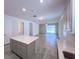 Open concept living and kitchen area with luxury vinyl floors and ample lighting at 10729 Planer Picket Dr, Riverview, FL 33569