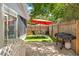 Backyard area with a patio, shade umbrella, grill, and fenced perimeter at 11026 Austin Ct, New Port Richey, FL 34654