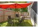 Fenced backyard with patio space, lawn, shade umbrella, and seating at 11026 Austin Ct, New Port Richey, FL 34654