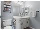 Bathroom with a toilet, vanity, mirror and shelves at 11026 Austin Ct, New Port Richey, FL 34654