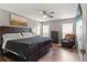 Comfortable bedroom featuring a ceiling fan, modern flooring, and stylish decor for a relaxing ambiance at 11026 Austin Ct, New Port Richey, FL 34654
