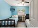 Cozy bedroom with two beds and blue walls at 11026 Austin Ct, New Port Richey, FL 34654