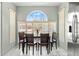 Bright dining area featuring a large window, tile floors, and a cozy table set for four at 11026 Austin Ct, New Port Richey, FL 34654