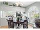Charming dining space with view of kitchen, decorative lighting, and seating for four around a wood table at 11026 Austin Ct, New Port Richey, FL 34654