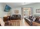 Living room featuring a sliding glass door and comfortable leather seating at 11026 Austin Ct, New Port Richey, FL 34654