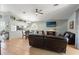 Spacious living room with tiled floors, ceiling fan, and view of the kitchen and dining area at 11026 Austin Ct, New Port Richey, FL 34654