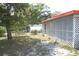The backyard features lattice accents, a swing, and a tree providing shade and a sense of privacy at 1146 Alma St, Clearwater, FL 33756