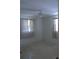 A corner bedroom with neutral walls, neutral flooring, basic curtains, and natural lighting at 1146 Alma St, Clearwater, FL 33756