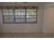 Dining room with tiled flooring, neutral walls, and large windows with lattice design, offering plenty of natural light at 1146 Alma St, Clearwater, FL 33756