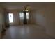 Spacious living room with neutral walls, ceiling fan and a large window with dark curtains at 1146 Alma St, Clearwater, FL 33756