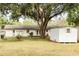 Spacious backyard with mature trees, shed, perfect for outdoor activities and relaxation at 12213 Floral Ln, Thonotosassa, FL 33592