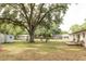Spacious backyard with mature trees, a deck area, shed and plenty of room for outdoor activities at 12213 Floral Ln, Thonotosassa, FL 33592