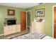 Comfortable bedroom with a dresser, TV, and soft lighting, creating a relaxing and inviting atmosphere at 12213 Floral Ln, Thonotosassa, FL 33592