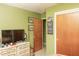 Cozy bedroom with vintage dresser, TV, and Tampa Bay Rays decor on the wall at 12213 Floral Ln, Thonotosassa, FL 33592
