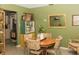 Bright dining area showcasing vintage decor, green walls and unique shelving at 12213 Floral Ln, Thonotosassa, FL 33592