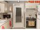 Cozy kitchen with retro appliances and a window-covered door to the backyard at 12213 Floral Ln, Thonotosassa, FL 33592