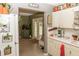 Bright kitchen with white cabinets, stainless steel appliances, and view into the dining area at 12213 Floral Ln, Thonotosassa, FL 33592