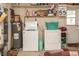 Functional laundry area in garage with washer, dryer, and water heater at 12213 Floral Ln, Thonotosassa, FL 33592