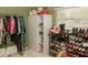 Well-organized walk-in closet featuring hanging clothes, shoe racks, and shelving at 12213 Floral Ln, Thonotosassa, FL 33592