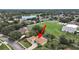 Aerial view highlighting a home with a screened-in pool and proximity to a school at 1312 Fishing Lake Dr, Odessa, FL 33556