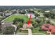 Aerial view showcasing the home's location near a school and tennis courts at 1312 Fishing Lake Dr, Odessa, FL 33556