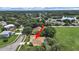 Aerial view of home with lake view and close proximity to schools and a large open field at 1312 Fishing Lake Dr, Odessa, FL 33556