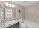 Well-lit bathroom featuring neutral tiling, granite countertop, and a shower-tub combination at 1312 Fishing Lake Dr, Odessa, FL 33556