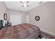 Cozy bedroom featuring dark furniture, ceiling fan, and neutral walls at 1312 Fishing Lake Dr, Odessa, FL 33556