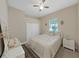 Cozy bedroom featuring a queen-sized bed, ceiling fan, and neutral walls at 1312 Fishing Lake Dr, Odessa, FL 33556