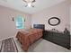 Cozy bedroom featuring dark furniture, ceiling fan, and neutral walls at 1312 Fishing Lake Dr, Odessa, FL 33556