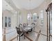 Elegant dining room featuring a chandelier, arched windows, and an open layout for seamless entertaining at 1312 Fishing Lake Dr, Odessa, FL 33556
