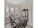 Formal dining room with a chandelier, decorative windows, and a large china cabinet for elegant displays at 1312 Fishing Lake Dr, Odessa, FL 33556