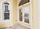 Close-up of front door with glass inserts, address numbers above and arched window at 1312 Fishing Lake Dr, Odessa, FL 33556