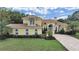 Well-manicured lawn, landscaped flower beds, and brick driveway enhance this charming home at 1312 Fishing Lake Dr, Odessa, FL 33556