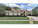 Charming two-story home with a well-maintained lawn and beautiful landscaping at 1312 Fishing Lake Dr, Odessa, FL 33556