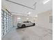 Spacious garage featuring concrete floors, car, and a roll-up garage door at 1312 Fishing Lake Dr, Odessa, FL 33556