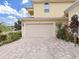 A spacious two-car garage and brick driveway with beautiful landscaped yard at 1312 Fishing Lake Dr, Odessa, FL 33556