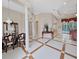 Elegant living room featuring a tile floor, decorative columns, and an open floor plan with access to pool at 1312 Fishing Lake Dr, Odessa, FL 33556