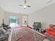 Spacious living room featuring high ceilings, a large rug, and an outdoor view at 1312 Fishing Lake Dr, Odessa, FL 33556