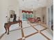 Open living room with tile flooring, fireplace, elegant furniture, and sliding glass doors leading to the pool at 1312 Fishing Lake Dr, Odessa, FL 33556