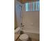 Tiled bathroom with a white bathtub and shower combination at 13231 Cherry Bark Cir, Riverview, FL 33579