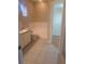 Bright bathroom featuring tub, toilet, neutral tile floors and closet access at 13231 Cherry Bark Cir, Riverview, FL 33579
