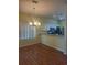 Dining room view of the open kitchen and a modern chandelier at 13231 Cherry Bark Cir, Riverview, FL 33579