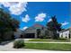 Charming single-story home with well-manicured lawn and mature landscaping under a bright blue sky at 13231 Cherry Bark Cir, Riverview, FL 33579