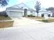 Well-kept single-Gathering home with attached two-car garage and a concrete driveway at 13231 Cherry Bark Cir, Riverview, FL 33579