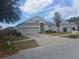 Well-kept single-Gathering home with attached two-car garage and a concrete driveway at 13231 Cherry Bark Cir, Riverview, FL 33579