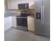 Well-equipped kitchen featuring stainless steel appliances, ample cabinetry, and tiled flooring at 13231 Cherry Bark Cir, Riverview, FL 33579